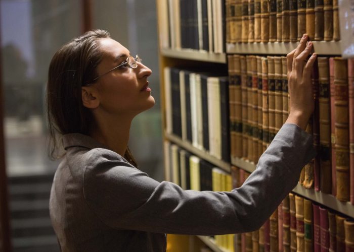 lawyer-picking-book-in-the-law-library-at-the-univ-P3WW6CN.jpg