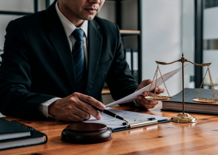 lawyer-working-document-with-scales-justice (1)